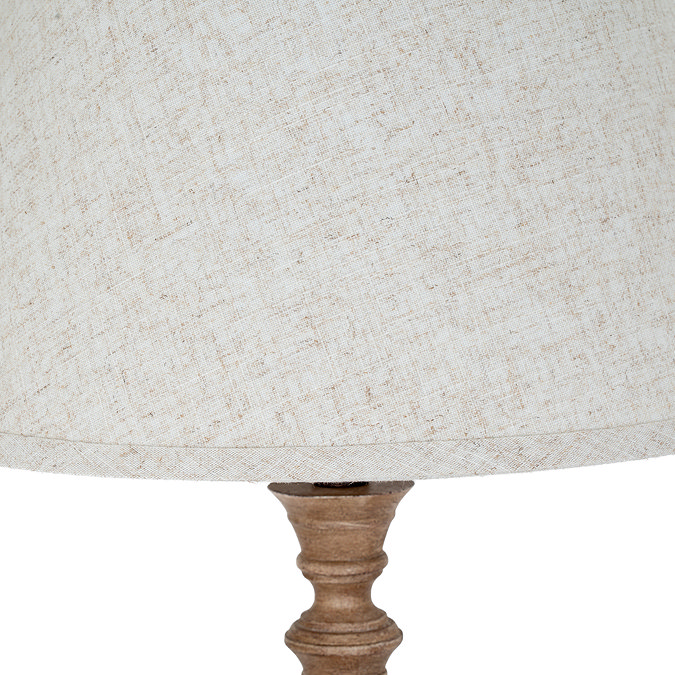 close up image of linen shade on top of a brown resin lamp