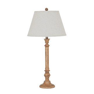 image cut out on white background of tall brown table lamp with edged linen shade