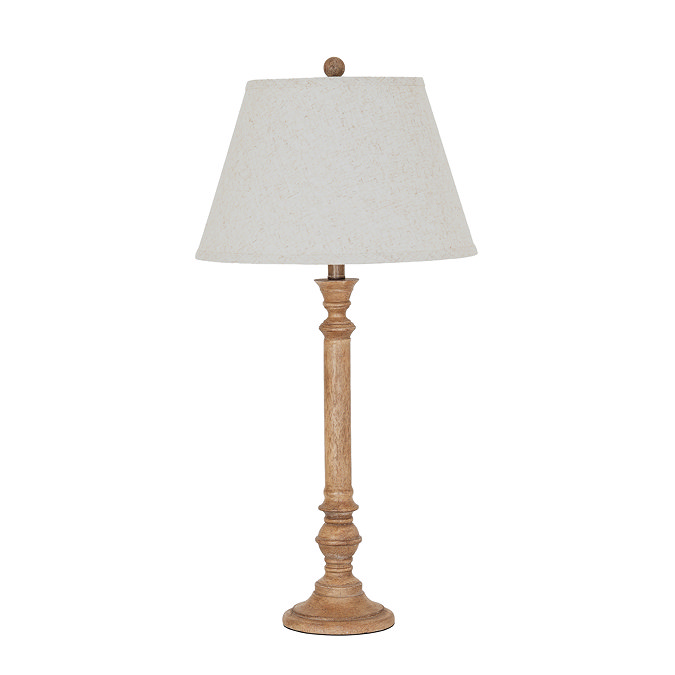 image cut out on white background of tall brown table lamp with edged linen shade