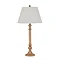 image cut out on white background of tall brown table lamp with edged linen shade