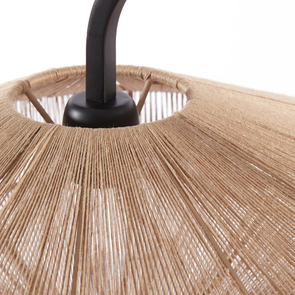 close up on point where black body of floor lamp curves into woven lamp shade
