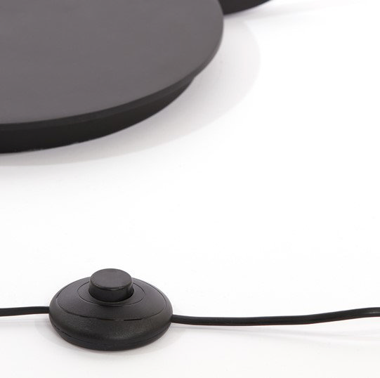 close up on push button of black metal floor lamp