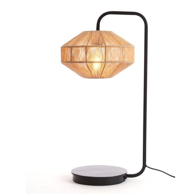 image cut out on white background of table lamp with black body and woven jute shade with light turned on to emit warm glow