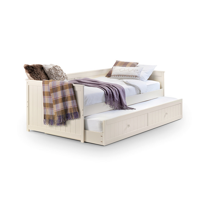 image cut out on white background of ivory panelled day bed, with drawer underneath for storage