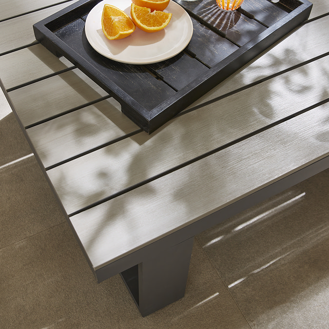 close up image on slatted wood-effect of outdoor garden table with tray of fruit on top