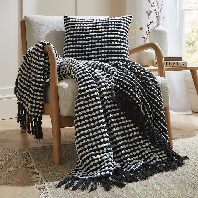 black stab stitch cushion with coordinating throw on chair