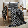 black stab stitch cushion with coordinating throw on chair