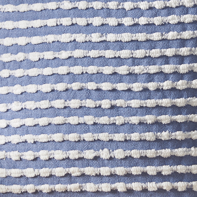 close up of blue and white stab stitch cushion pattern