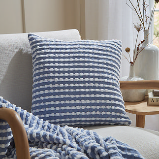stab stitch blue cushion on a chair