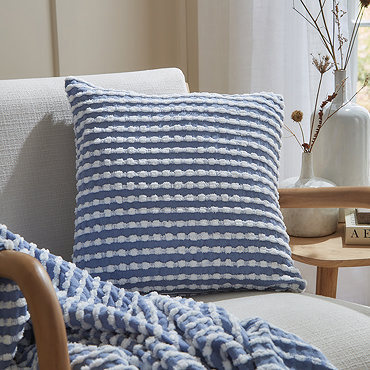 close up of blue and white stab stitch cushion pattern