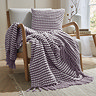 lilac stab stitch cushion with coordinating throw on a chair