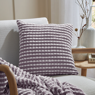 lilac stab stitch cushion on a chair