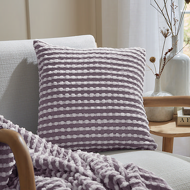 close up of lilac stab stitch cushion in light purple