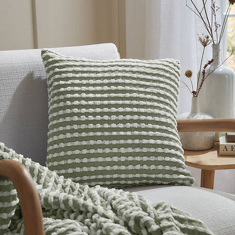 sage green stab stitch cushion on a chair
