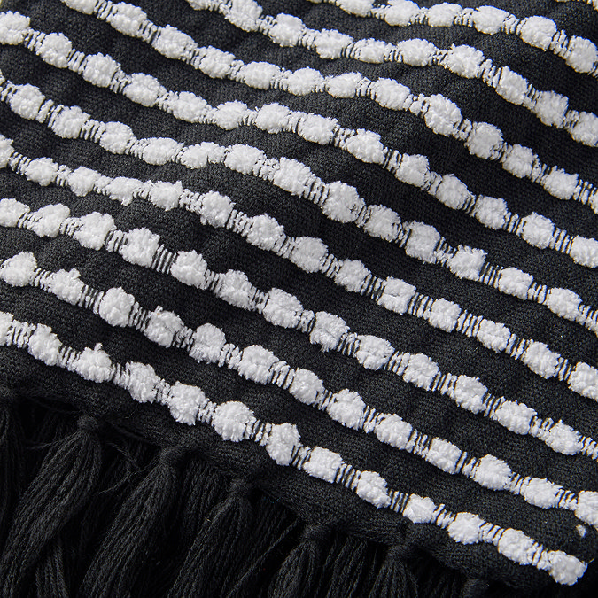 close up of black and white stab stitch throw pattern