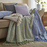 group of stab stitch throws in various colours with coordinating cushions