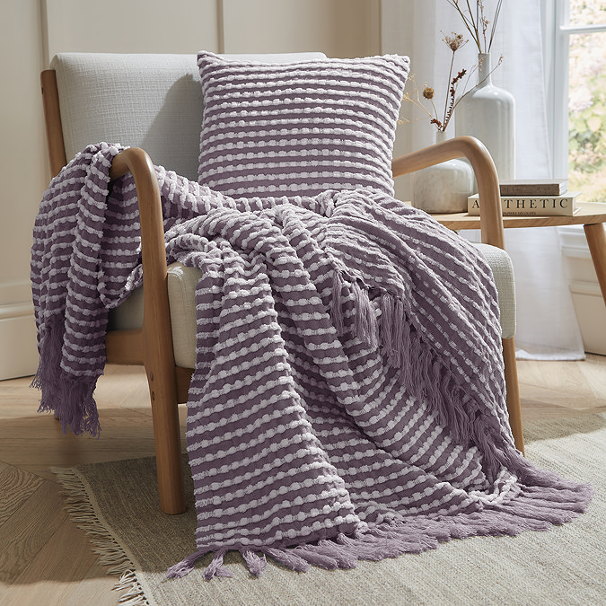 lilac stab stitch throw and coordinating square cushion on a chair