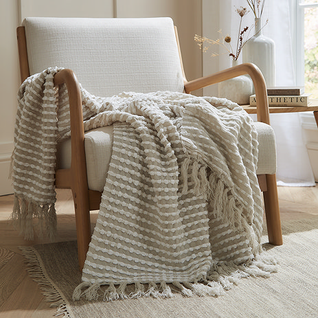 natural stab stitch throw draped over a chair