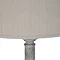 close up image of natural linen shade with grain, on top of white resin lamp
