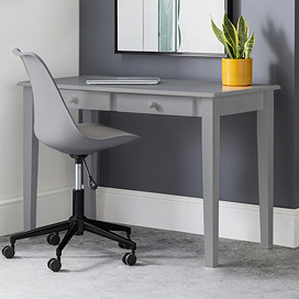image of classic grey desk with two drawers pushed against grey wall, with matching grey chair pushed slightly underneath.