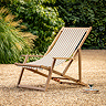 image of clay pink and white striped deckchair on sandy gravel of back garden