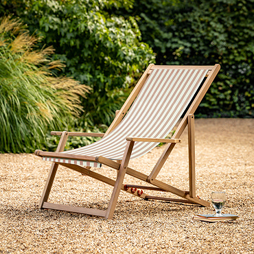 close up image of acacia wood frame of clay pink and white striped sun lounger