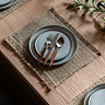 image of striped jute woven placemat with plate and cutlery on top