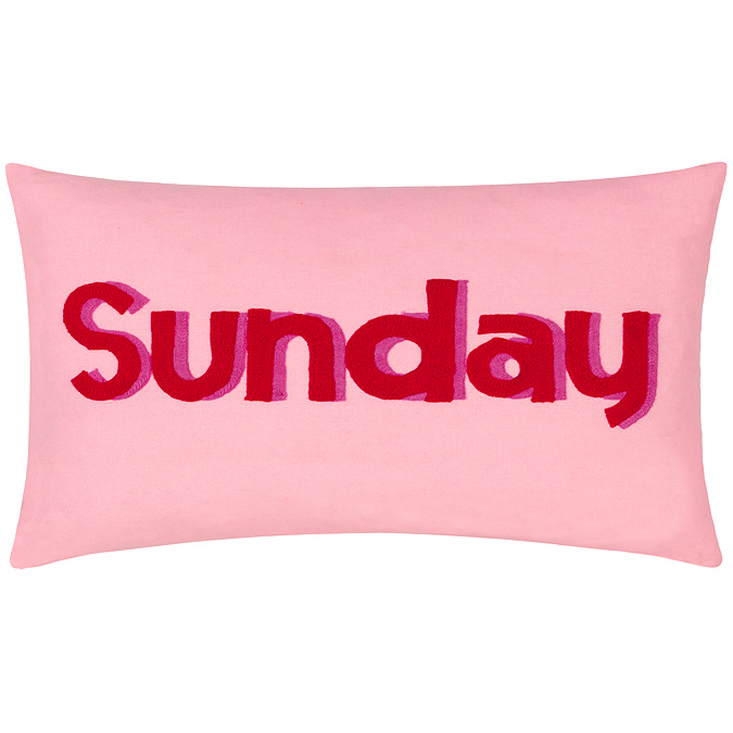 image cut out on white background of rectangular pink cushion with 'sunday' written in dark pink