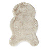 image cut out on white background of sheepskin wiggle shape rug in beige