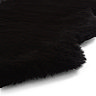 close up image of wavy edges of black sheepskin rug