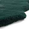 close up image on wavy edges of soft dark green rug