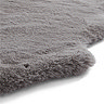 close up image of wavy corners of grey skeepskin rug