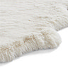 close up image on wavy edges of soft ivory rug