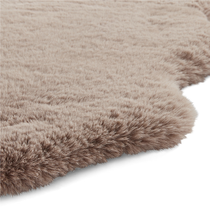 close up image of wavy edged mink brown rug with soft pile