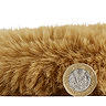 side-on image of faux sheepskin rug with pound coin stood up next to it to show rug as double the height of coin