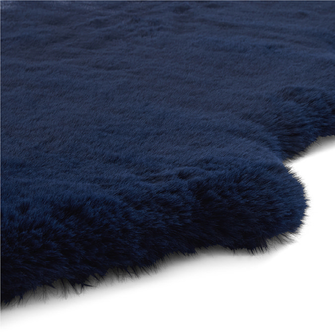close up image on wavy edges of soft navy blue rug