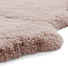close up image on wavy edges of rose pink rug