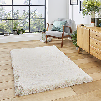 image of soft beige rug in middle of wooden flooring