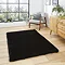image of black soft rug on wooden flooring in front of wooden sideboard