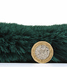 side on image of emerald green rug with pound coin stood up next to it to show rug as double height of coin