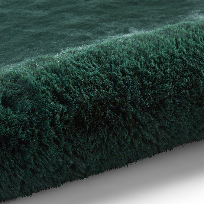 image of soft emerald green rug rolled over at one end
