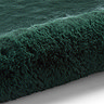 image of soft emerald green rug rolled over at one end
