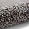 image of soft grey rug rolled up at one end