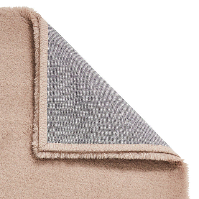 image of soft mink brown rug with corner folded over to reveal floor-facing material underneath