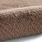 close up on mink brown soft rug rolled up on one end