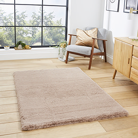 image of mink brown soft rectangle rug on light wooden flooring of modern loft apartment