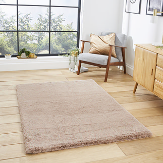 image of mink brown soft rectangle rug on light wooden flooring of modern loft apartment