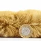 side on image of yellow soft fluffy rug with pound coin stood up next to it to show rug as double height of coin
