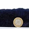 side on image of navy blue rug flat with pound coin stood up next to it to show rug as double height of coin