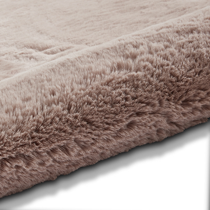 image of soft rose pink rug rolled up on one end